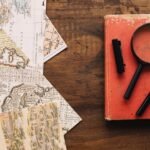 book-magnifying-glass-near-maps_23-2147793484